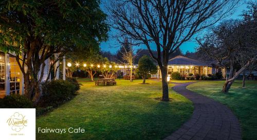 a walkway in a park at night with lights at Wairakei Resort Taupo in Taupo