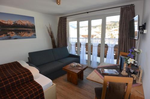 a living room with a couch and a table at Haus Erli in Mittenwald