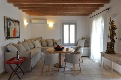 a living room with a couch and a table at Aegea Blue Cycladic Resort in Zorgos 