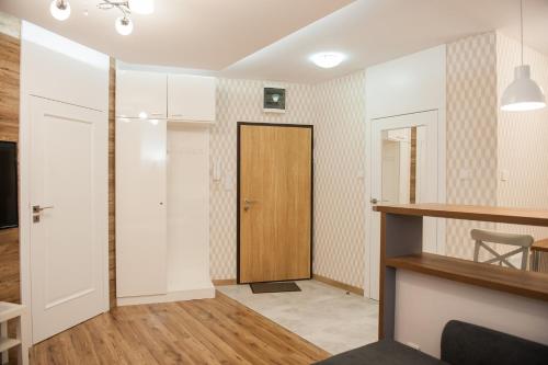 ein Wohnzimmer mit einer Tür und einem Flur in der Unterkunft Apartament Smolna - Zawady in Posen