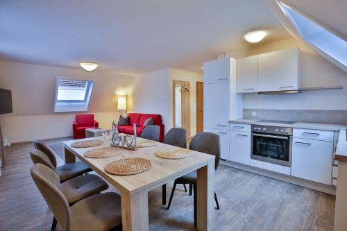 a kitchen and dining room with a table and chairs at Hotel Ochsen in Ammerbuch