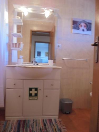 a bathroom with a sink and a mirror at CasaDuarte "doMar" in Lagos