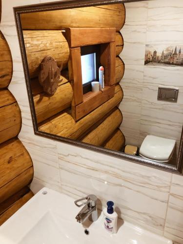 a bathroom with a sink and a mirror at Зимова казка in Tatariv