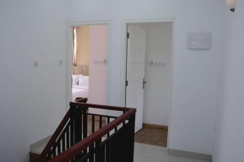 a staircase leading to a room with a bedroom at Diyar Villas Puncak K3/2A in Puncak