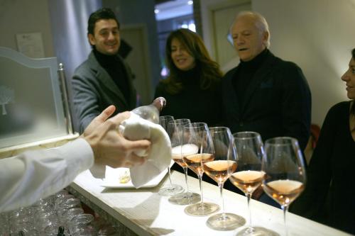 a group of people standing around a table with wine glasses at Hotel Noce in Brescia