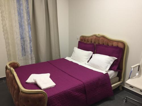 1 dormitorio con cama morada y manta morada en STYLE HOTEL en París