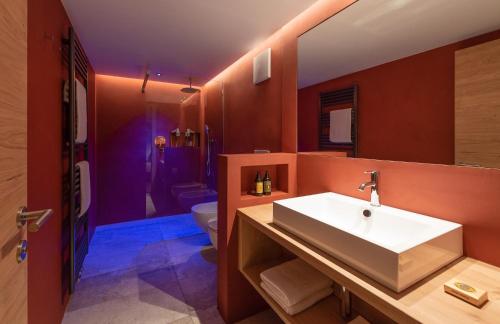 a bathroom with a sink and a toilet at Residence Sovara in Santa Cristina in Val Gardena