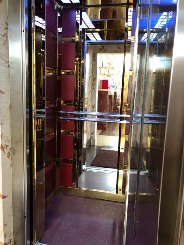 a revolving door with a mirror in a room at Khujand Deluxe Hotel in Khujand