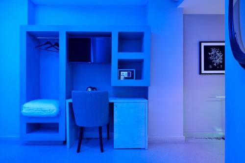 a blue room with a table and a chair at Villa La Fenice in Reggio Calabria