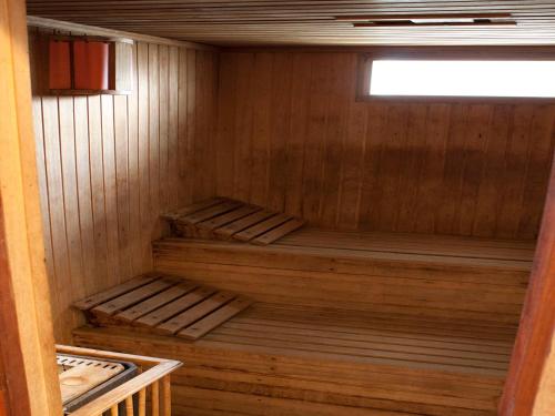a wooden sauna with two wooden shelves in it at Costa Carilo Apart de Mar By HS in Carilo