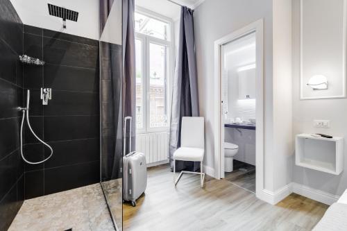 a bathroom with a shower and a toilet at Opera Private Suites by Premium Suites Collection in Rome