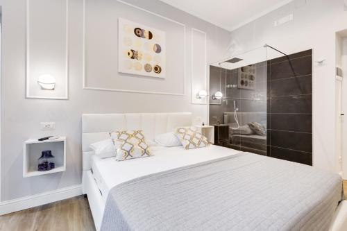 a white bedroom with a bed and a shower at Opera Private Suites by Premium Suites Collection in Rome