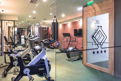 a gym with treadmills and elliptical machines at Solun Hotel & SPA in Skopje