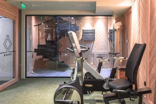 a room with a gym with a bike in front of a window at Solun Hotel & SPA in Skopje