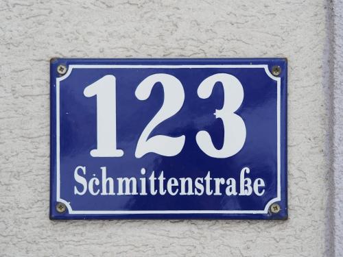 a blue and white sign on the side of a building at Pension Margarete in Zell am See