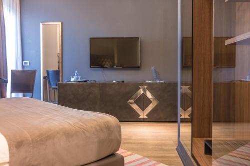 a hotel room with a bed and a television at Solun Hotel & SPA in Skopje