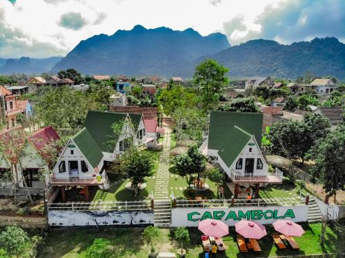 an aerial view of a village with houses and umbrellas at Carambola Bungalow in Phong Nha