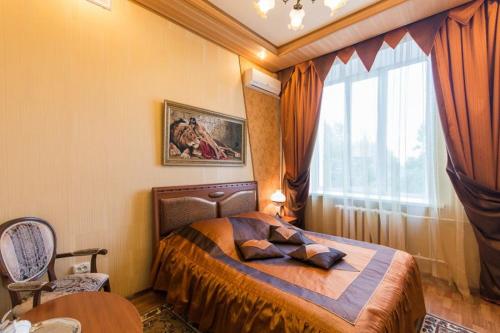 a bedroom with a bed and a large window at Profsoyuznaya Hotel in Nizhny Novgorod