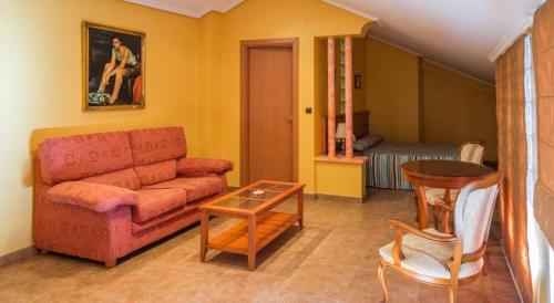 a living room with a couch and a table at Hotel Real de Castilla in Tordesillas