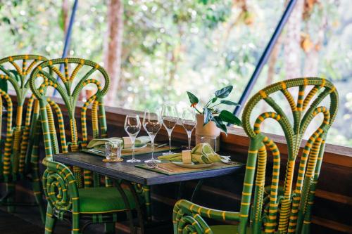 a table in a restaurant with glasses of wine at Shinta Mani Wild- A Bensley Collection in Kampong Seila