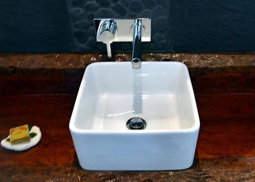 a white sink with a faucet and a piece of cheese at Wongari Eco Retreat in Lamington
