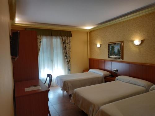 Postel nebo postele na pokoji v ubytování Hotel Real de Castilla