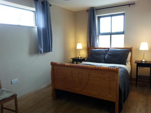 a bedroom with a bed and a window at Blackberry Lodge Accommodation in Doolin