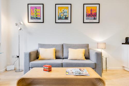 a living room with a couch and a coffee table at Nell Gwynn Chelsea Accommodation in London