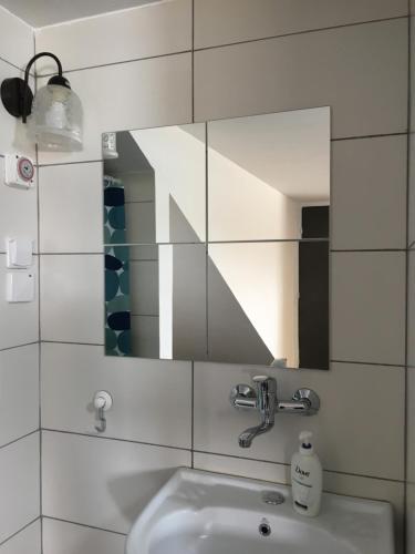 a bathroom with a sink and a mirror at Hassan Guesthouse in Nazareth