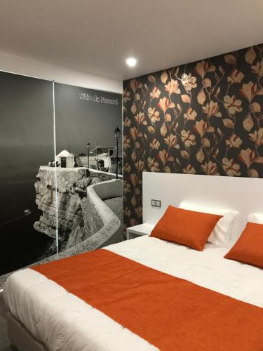 a bedroom with a large bed with orange pillows at PinoyHouse Fatima in Fátima