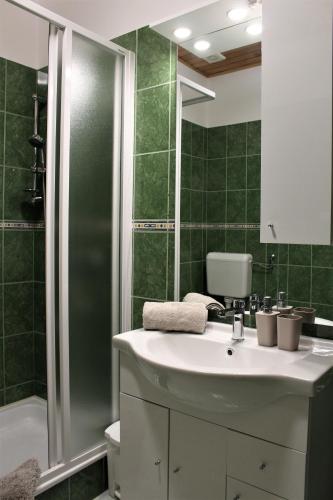 a bathroom with a sink and a shower at Margaret Apartment in Balatonkeresztúr