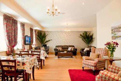 
a living room filled with furniture and a large window at Kinvara Guesthouse in Kinvara
