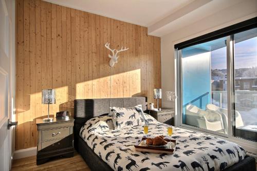 a bedroom with a bed with a tray of food on it at Le Kaméléon 318 : interieur parking, rooftop terrace, gym in Quebec City