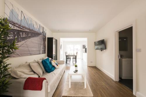 a living room with a couch and a table at High End Apartments in Hendon