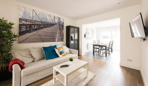 a living room with a couch and a table at High End Apartments in Hendon