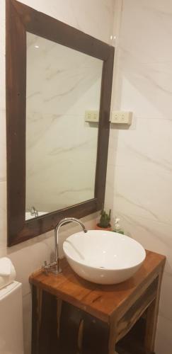 a bathroom with a white sink and a mirror at DiveGurus Boracay Beach Resort in Boracay