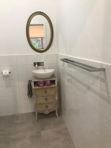 a bathroom with a sink and a mirror at Forest View in Creswick