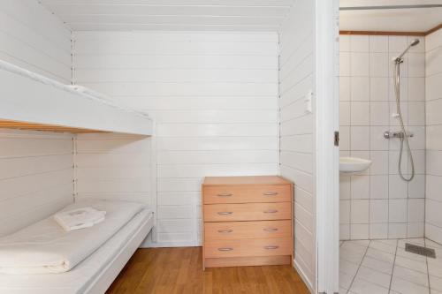 a bathroom with a bed and a shower and a sink at Midttun Motell & Camping AS in Bergen