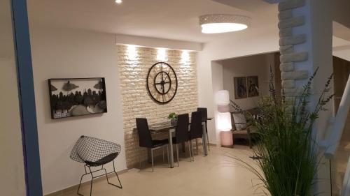 a dining room with a table and black chairs at Amazing in Haifa