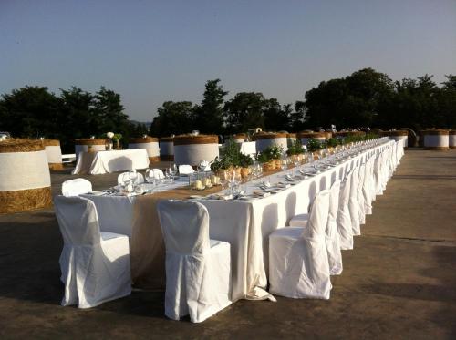 a long line of white tables and chairs at Antonello Colonna Resort & Spa in Labico