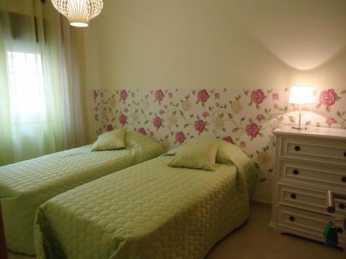 a bedroom with two beds and a dresser at Quarto in Alvor