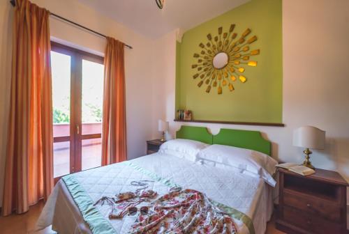 a bedroom with a bed and a mirror on the wall at Hotel Villa Sirina in Taormina