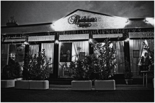 a store front with potted plants in front of it at Balthasar Neumann Speiserei & Gästehaus - Zentrum Brühl -E-Ladestation, nähe Phantasialand in Brühl