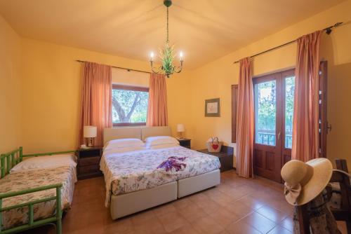 a bedroom with two beds and a window at Hotel Villa Sirina in Taormina