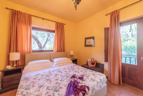 a bedroom with a bed and a large window at Hotel Villa Sirina in Taormina