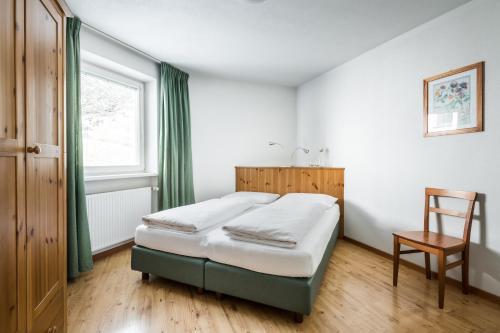 Ένα ή περισσότερα κρεβάτια σε δωμάτιο στο Apartments Mühlegg