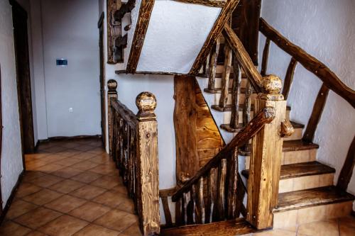 a hallway with a wooden staircase with a mirror at SPA HOTEL Gora in Bukovel