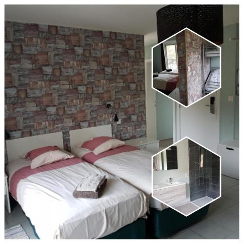 a bedroom with two beds and a brick wall at De Hollemeersch Hotel in Dranouter