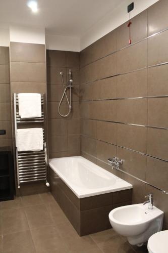 a bathroom with a tub and a toilet and a sink at B&b My Bergamo in Bergamo