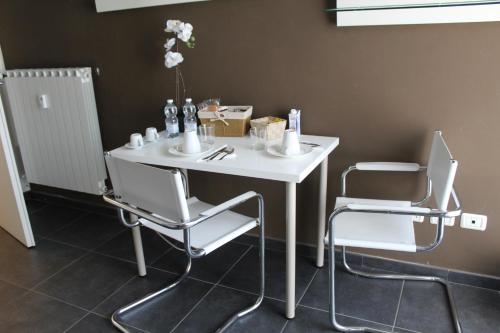 a white table and two chairs in a room at B&b My Bergamo in Bergamo